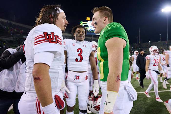 Utah Utes quarterback Cameron Rising (7), left, talks to Oregon Ducks quarterback Bo Nix (10) after a game at Autzen Stadium. The Ducks won the game 20-17.